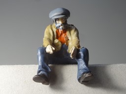 Zeige Details für Mann sitzend, auf den Boden sehend Bild von Mann sitzend, auf den Boden sehend